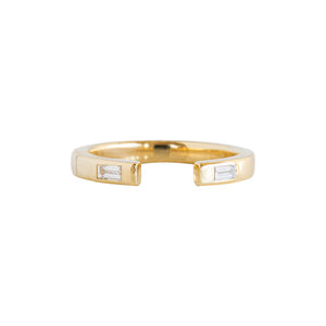 Open wedding band with flush-set baguettes and a gap in the middle on a white background. 