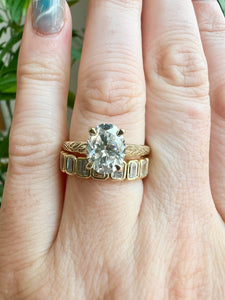 Our yellow gold Annalise Oval engagement ring with lavender engraving on the band shown stacked with our yellow gold Rhodes Half Eternity Band. 