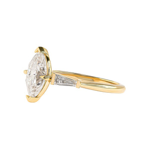 Elegant, art-deco inspired marquise cut engagement ring with tapered baguettes. Cathedral setting.