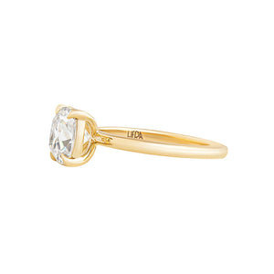 Yellow gold solitaire engagement ring with claw prongs, set with an Old Mine Cut lab diamond or moissanite.