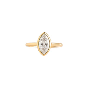 Bezel set marquise lab diamond moissanite engagement ring in yellow gold.