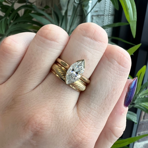 Yellow gold antique inspired wedding band. Striped engraving. Wide band. Stacked on hand with Presley Marquise Lab Grown Engagement Ring.
