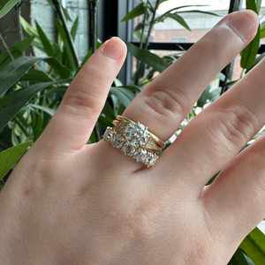 Yellow gold old European or round brilliant accented engagement ring. Eight-prong Victorian crown basket. Diamond accented side triangles. Floating gallery cathedral. Stacked on hand with Prague and London Band.