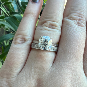 White gold Old Mine cut cathedral engagement ring, with hand wheat engraving inspired by the Art Deco period. Shown on hand stacked with Athens band.