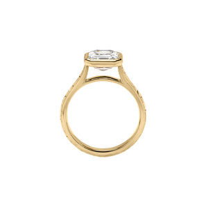 Yellow gold Asscher cut bezel engagement ring with a hand engraved floral band. Gallery view.