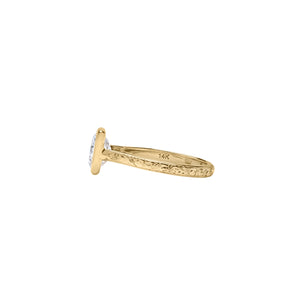Yellow gold Asscher cut bezel engagement ring with a hand engraved floral band. Side view.