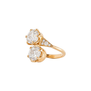 Two-stone toi et moi yellow gold engagement ring set with Old European Cut round moissanite or lab diamonds with one on top of the other. Triangle-shaped sides with lab diamonds. Side view.