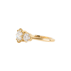 Trilogy three-stone yellow gold Old European Cut moissanite or lab diamond engagement ring. Eight prong center and six prong sides set in Victorian crown baskets. Side view.
