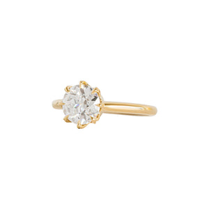 Yellow gold eight-prong solitaire engagement ring set with Old European Cut round moissanite or lab diamond. Knife edge band and integrated basket. Side view.