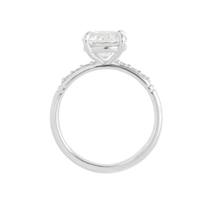 White gold moissanite or lab diamond round brilliant hearts & arrows cut engagement ring with lab diamond pave and antique engraving on a white background. Peg head setting. Gallery view. 