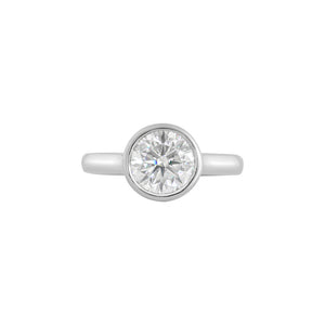 White gold bezel-set round brilliant hearts & arrows cut moissanite or lab diamond solitaire engagement ring on a white background. Floating gallery cathedral. Front view.