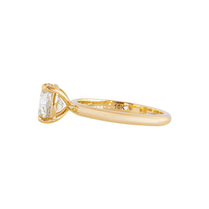 Yellow gold four-prong classic solitaire peg head round brilliant hearts & arrows moissanite or lab diamond engagement ring on a white background. Side view.