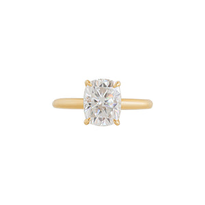 Yellow gold four-prong classic solitaire peg head elongated cushion moissanite or lab diamond engagement ring on a white background. Front view.