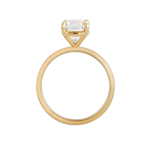 Yellow gold four-prong classic solitaire peg head elongated cushion moissanite or lab diamond engagement ring on a white background. Gallery view.