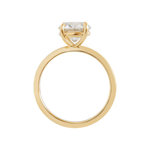 Yellow gold four-prong classic solitaire peg head round brilliant hearts & arrows moissanite or lab diamond engagement ring on a white background. Gallery view.