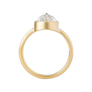 Yellow gold bezel-set engagement ring with hand-carved milgrain and integrated basket, on a white background. Set with a rose cut chubby pear moissanite or lab diamond. Gallery view. 