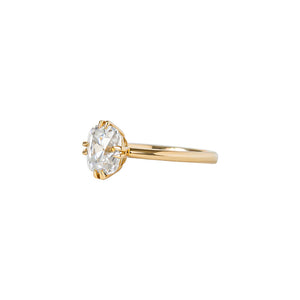 Yellow gold engagement ring with compass-set NSEW double claw prongs, set with an Old Mine Cut cushion moissanite or lab diamond. Knife edge band and integrated basket. Side view.