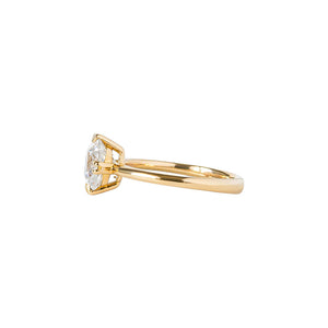 Yellow gold engagement ring with compass-set NSEW double claw prongs, set with an Old Mine Cut cushion moissanite or lab diamond. Knife edge band and integrated basket. Side view.
