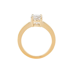 Yellow gold oval moissanite or lab diamond engagement ring on a grooved band with ridges, on a white background. Integrated basket. Gallery view. 