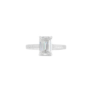 White gold flat band emerald cut engagement ring, with hand wheat engraving inspired by the Art Deco period. Corner claw prongs. Front view.