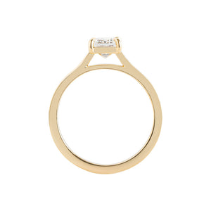 Yellow gold flat band emerald cut engagement ring, with hand wheat engraving inspired by the Art Deco period. Corner claw prongs. Side view.