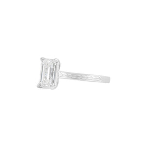 White gold flat band emerald cut engagement ring, with hand wheat engraving inspired by the Art Deco period. Corner claw prongs. 
